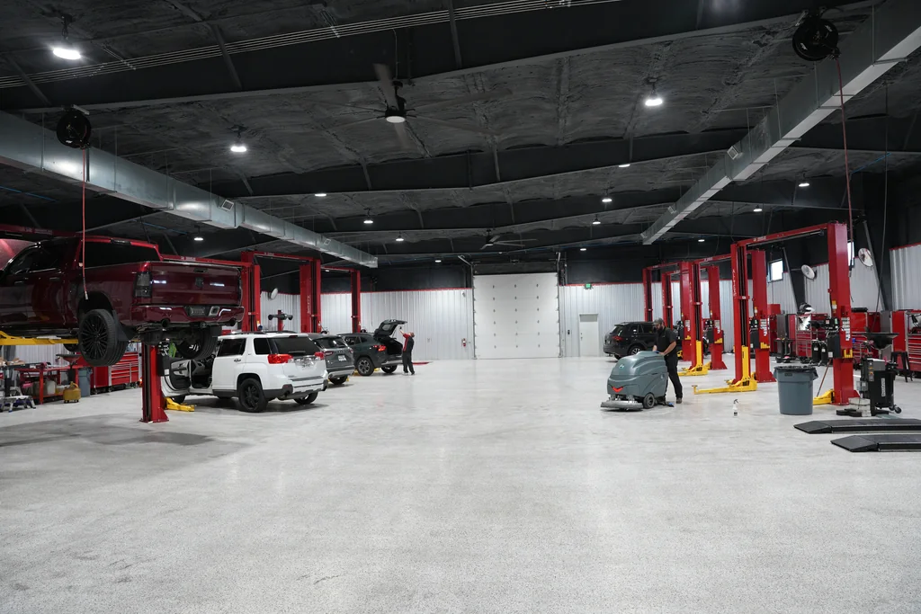 Open service bays with vehicle lifts and workshop equipment.