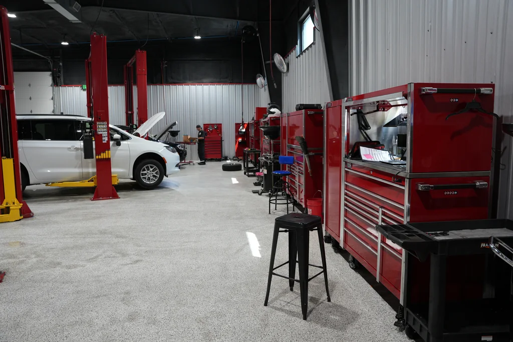 Workshop tool cabinets beside vehicle service bays.
