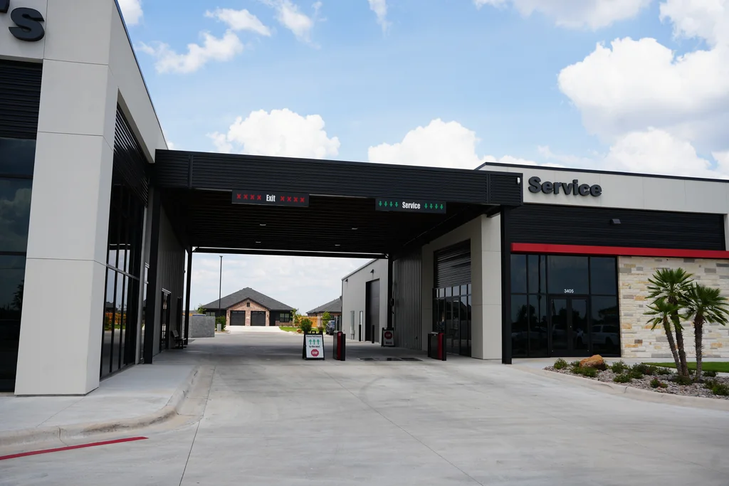 Exterior of the service building with an open vehicle entrance.
